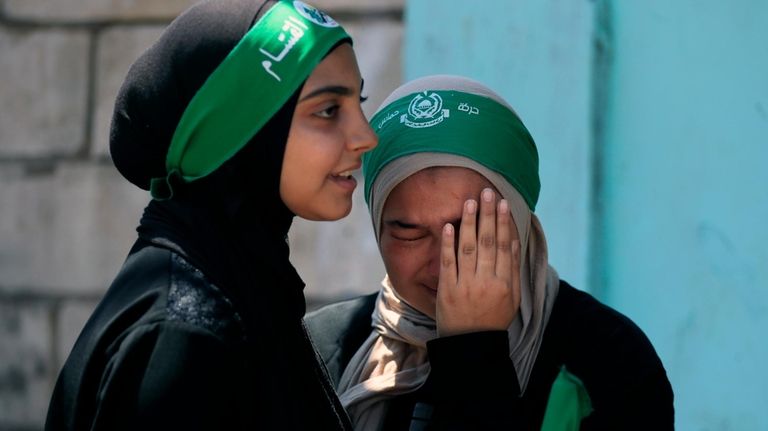 A young woman reacts during a protest to condemn the...