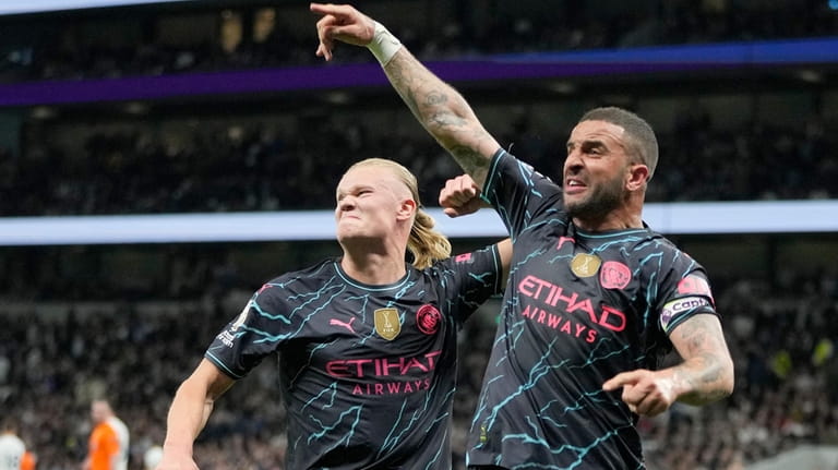 Manchester City's Erling Haaland and Manchester City's Kyle Walker celebrate...