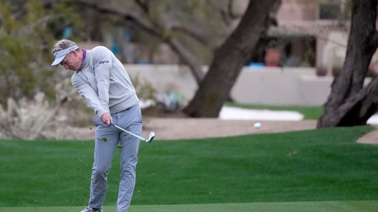 Luke Donald, of England, hits from the fairway at the...