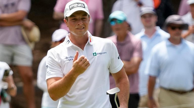 Viktor Hovland, of Norway, reacts to his putt on the...