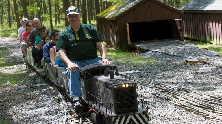 A member of the Long Island Live Steamers give passengers...