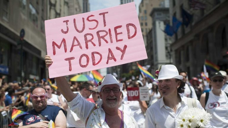 Participants march in the 2013 NYC Pride parade, which was...