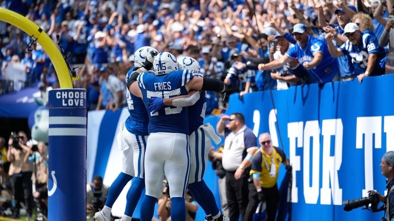 Indianapolis Colts running back Jonathan Taylor, right, celebrates a touchdown...