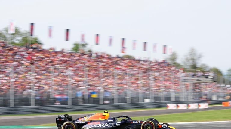 Red Bull driver Sergio Perez of Mexico steers his car...