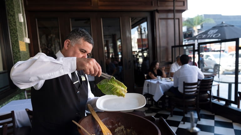 Salad Master Efrain Montoya prepares a Caesar salad at Ceasar's...