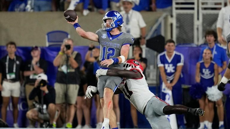 Kentucky quarterback Brock Vandagriff (12) is hit by Georgia linebacker...