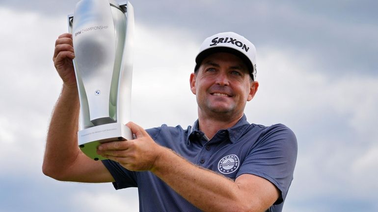 Keegan Bradley holds up the BMW Championship trophy after winning...