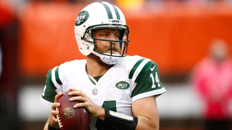 Ryan Fitzpatrick of the New York Jets looks to pass...