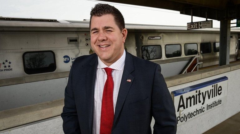 Amityville trustee Nick LaLota stands atop the Long Island Rail...