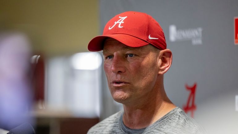 Alabama head coach Kalen DeBoer talks with the media following...