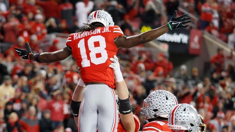 Ohio State receiver Marvin Harrison (18) celebrates after his touchdown...