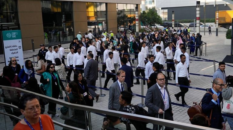 Delegates arrive for the day at the COP28 U.N. Climate...