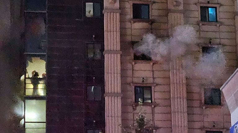 Firefighters work to extinguish a fire at a hotel in...