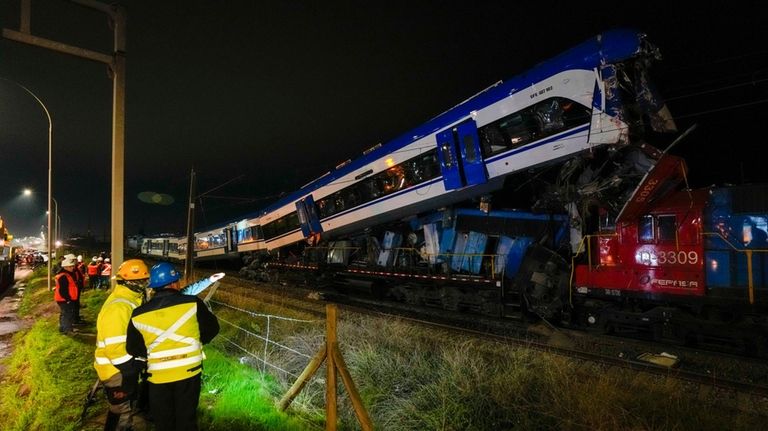 Police inspect two trains that collided in San Bernardo, Santiago,...