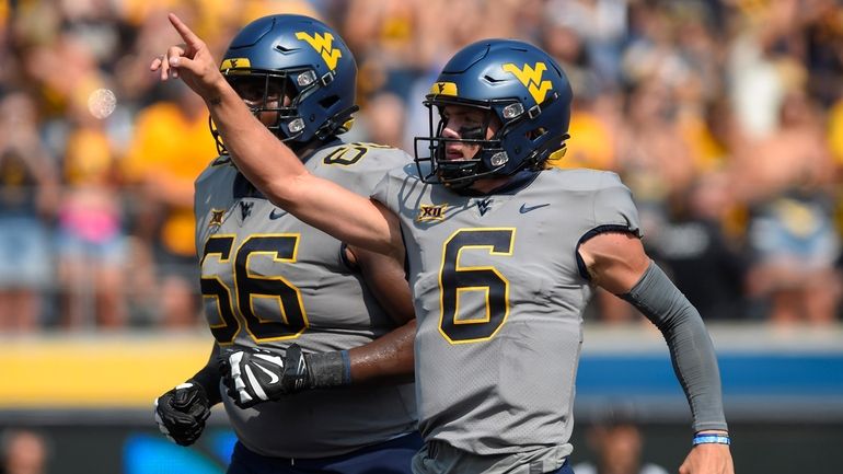 West Virginia quarterback Garrett Greene (6) reacts after a play...