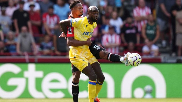 Brentford's Ethan Pinnock, left, and Crystal Palace's Jean-Philippe Mateta battle...