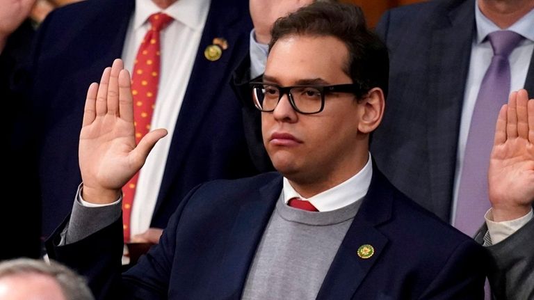 Rep. George Santos is sworn in by Speaker of the...