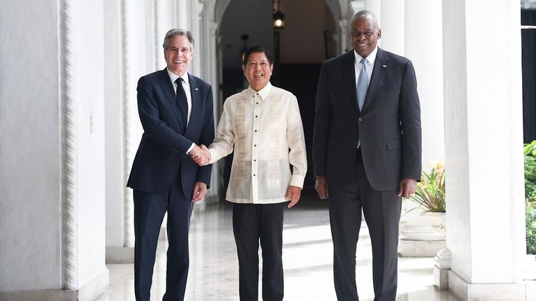 Philippine President Ferdinand Marcos Jr., center, greets U.S. Secretary of...