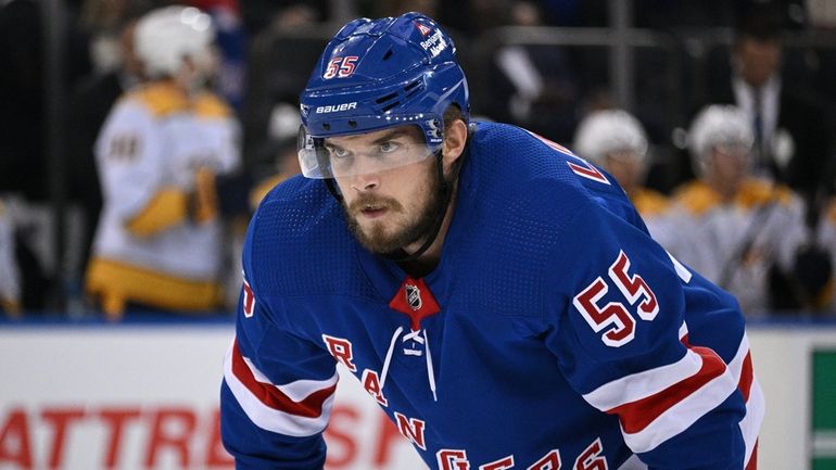 Rangers defenseman Ryan Lindgren sets before a face off against...