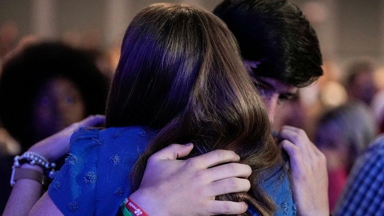 An Apalachee High School student is embraced during a Sunday...