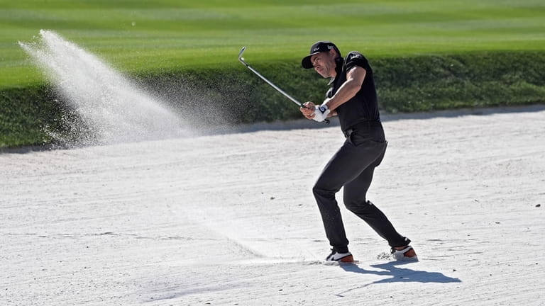 Camilo Villegas, of Colombia, hits from the sand trap on...