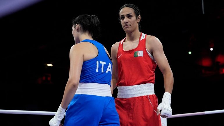 Algeria's Imane Khelif, right, walks beside Italy's Angela Carini after...