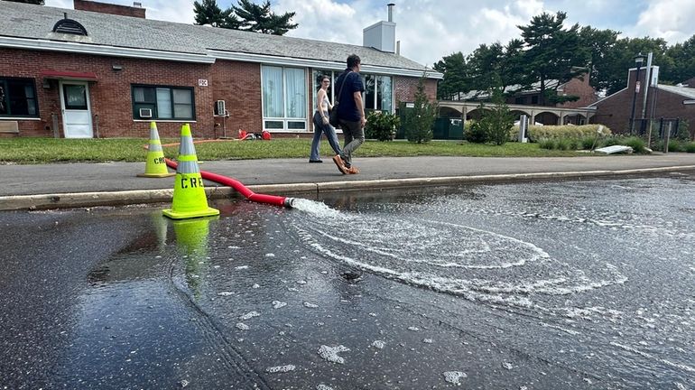 Water is pumped out of Ammann Hall at Stony Brook...