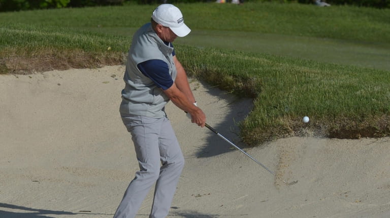 Steve Stricker hits out of a bunker on the first...