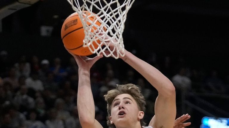 Kansas guard Johnny Furphy (10) goes to the basket as...