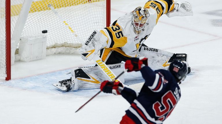 Winnipeg Jets' Mark Scheifele (55) scores on Pittsburgh Penguins goaltender...