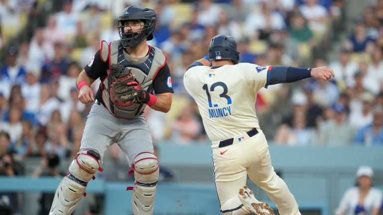 Los Angeles Dodgers' Max Muncy (13) scores off of a...