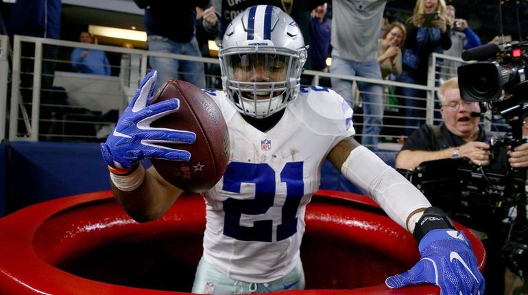 Ezekiel Elliott of the Dallas Cowboys celebrates after scoring a...