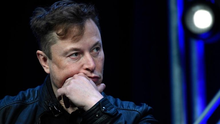 Tesla and SpaceX chief executive officer Elon Musk listens to...