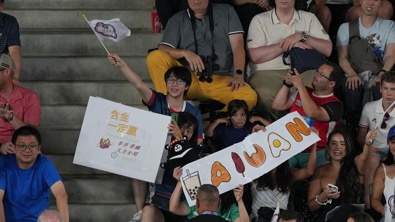 A fan hold a sign that reads "Sure Win" during...