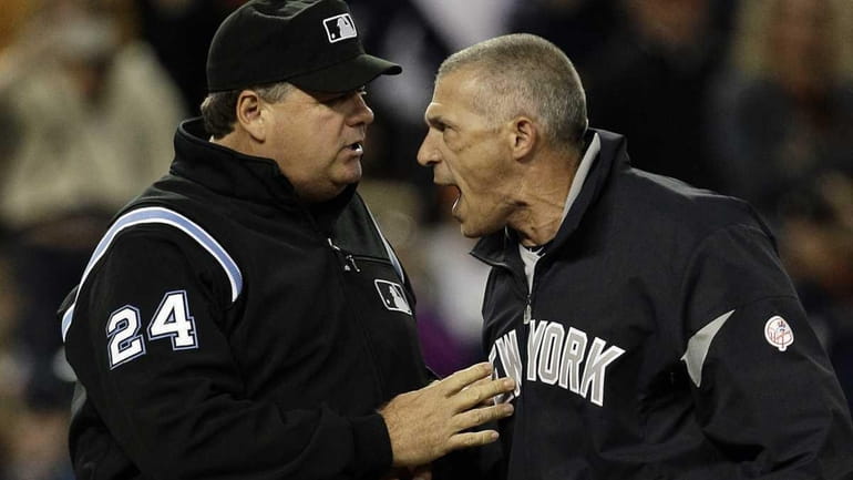 Umpire Jerry Layne (24) restrains Yankees manager Joe Girardi who...