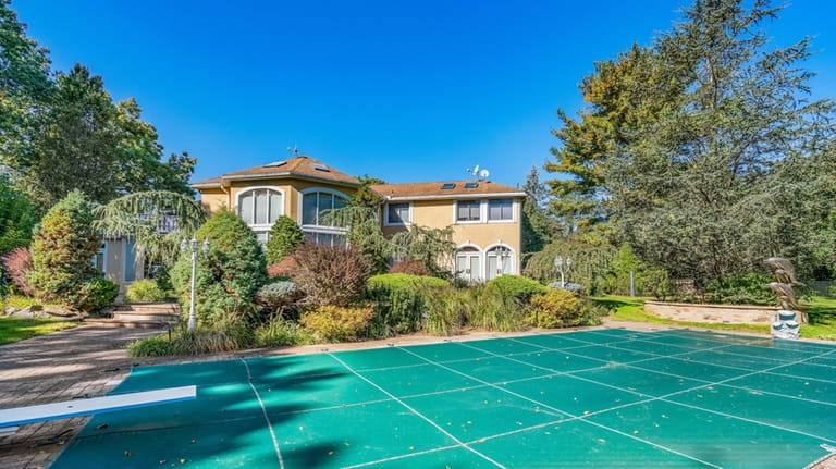 The property features an in-ground pool, tennis court and maintained...
