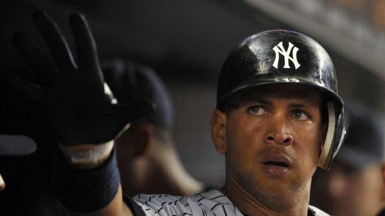 Yankees third baseman Alex Rodriguez is congratulated after scoring in...