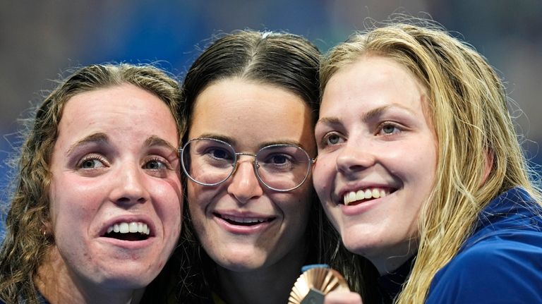 Gold medalist Kaylee McKeown, of Australia, center, poses with silver...