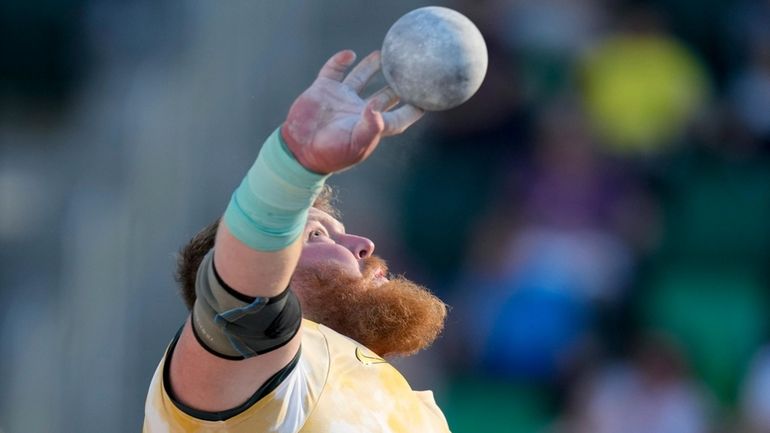 Ryan Crouser competes in the men's shot put final during...