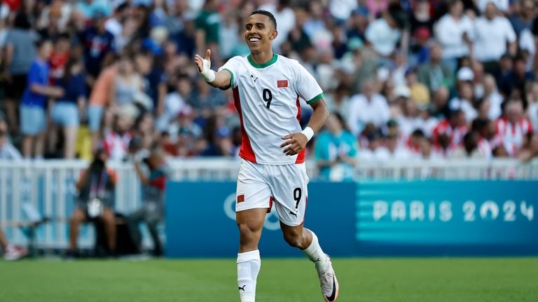 Morocco's Soufiane Rahimi celebrates after scoring his side's fourth goal...