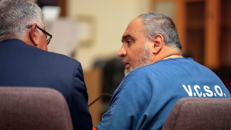 Attorney Ron Bamieh, left, listens to his client, Loay Abdelfattah...
