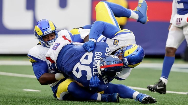 Saquon Barkley of the Giants is tackled in the second half...