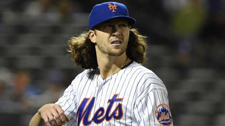 New York Mets starting pitcher Jacob deGrom walks to the...