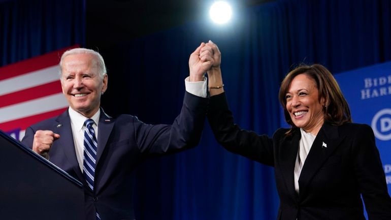 President Joe Biden and Vice President Kamala Harris stand on...