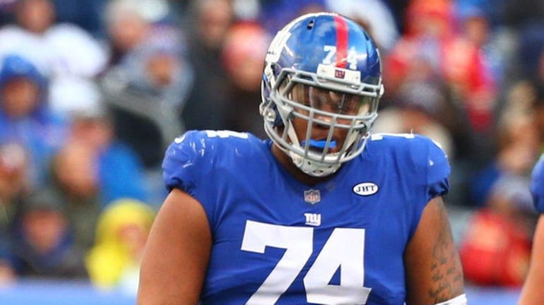 Eli Manning #10 and Ereck Flowers #74 of the New...