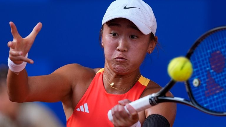 Wang Xiyu of China returns a forehand shot to Iga...