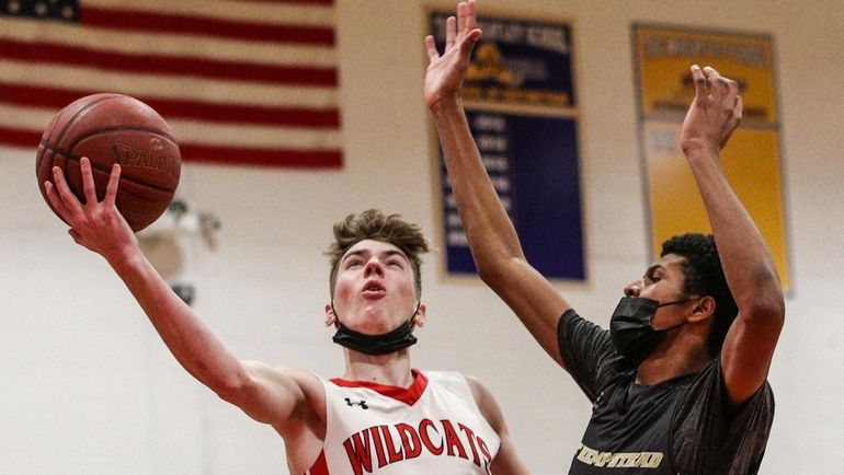 Jimmy O'Connell of Wheatley staves off the defensive move by...