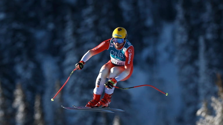 Switzerland's Niels Hintermann is airborne during an alpine ski, men's...
