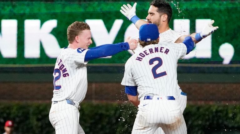 Chicago Cubs pinch-hitter Mike Tauchman, top right, celebrates after his...