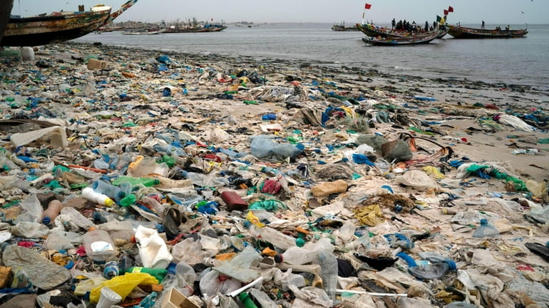 Trash and plastics litter the sand of Yarakh Beach in...